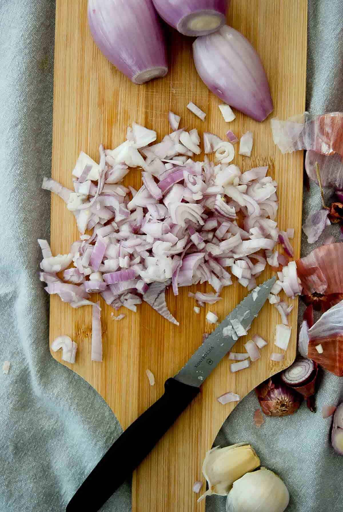 chopped onion and garlic on cutting board.
