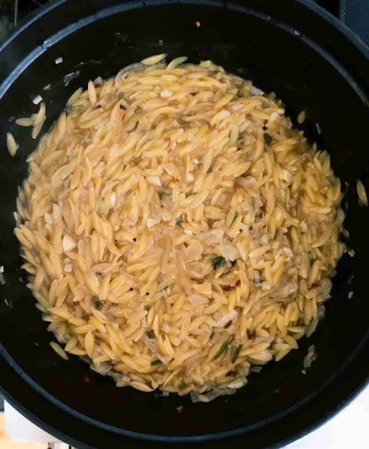 cooked creamy orzo in broth.