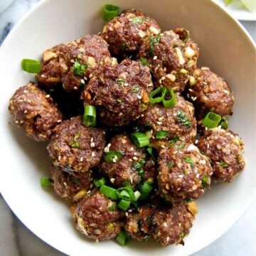 Closeup of Firecracker Meatballs with scallions in bowl.