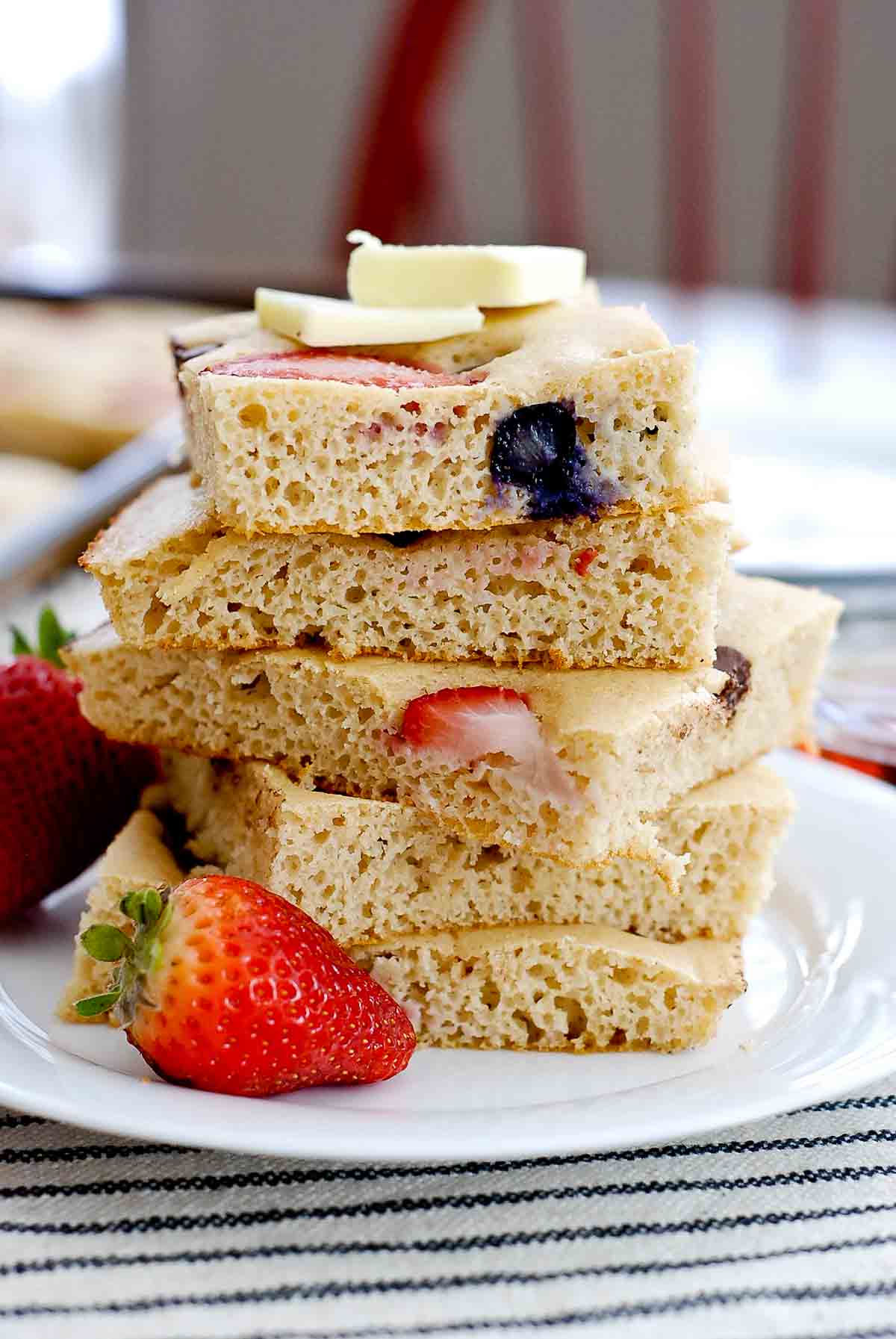 stack of square pancakes with 2 butter tabs.