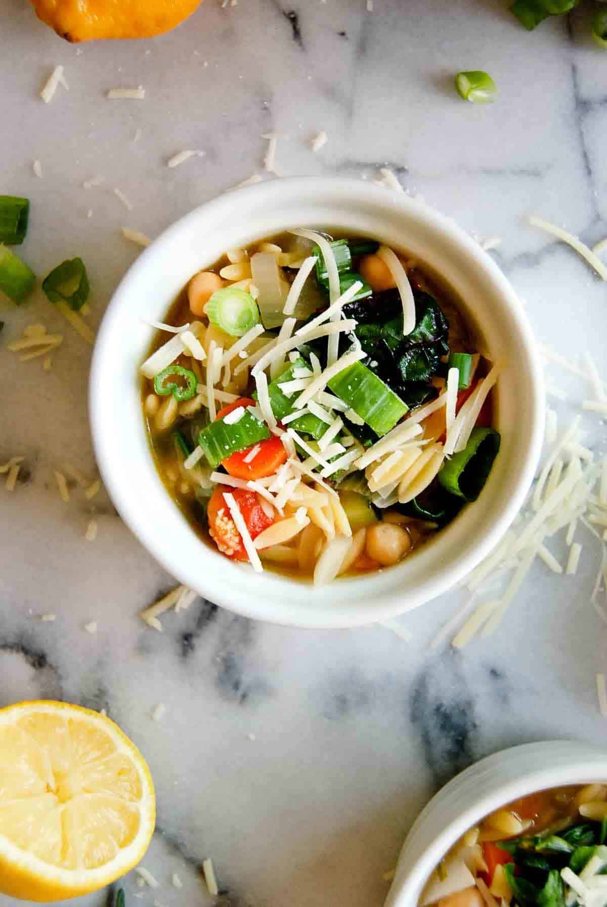 small bowl with orzo soup and parmesan.