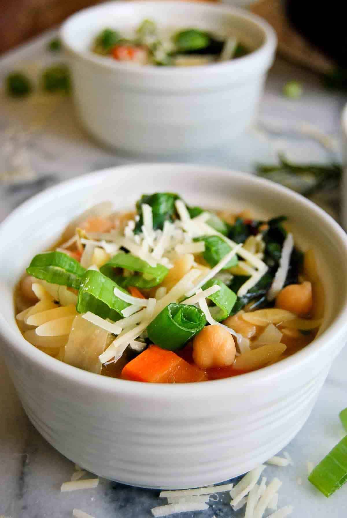 side view of bowl of lemony orzo soup.