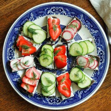 cucumber tea sandwiches, strawberry tea sandwiches, and radish tea sandwiches on platter.