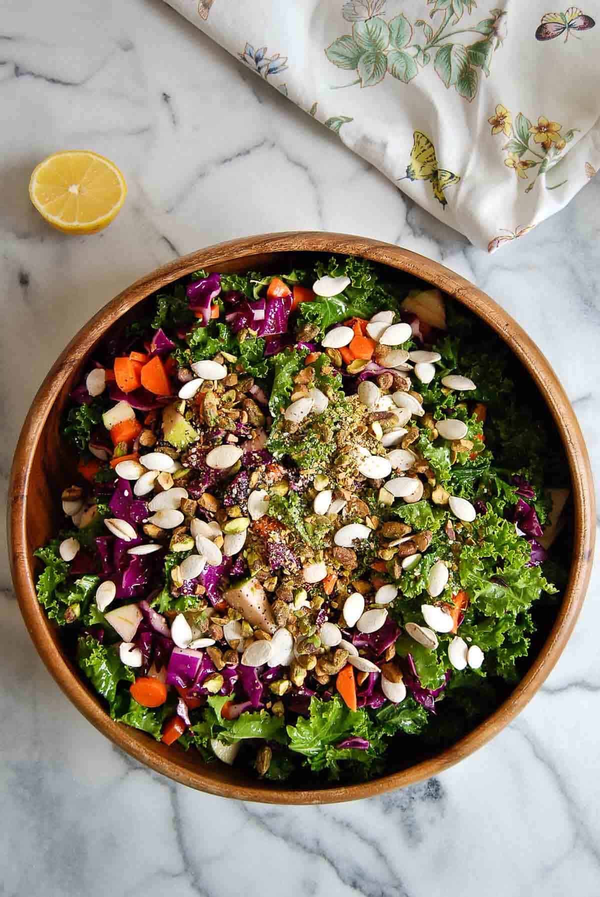 easy super crunch salad in bowl with lemon on the side.