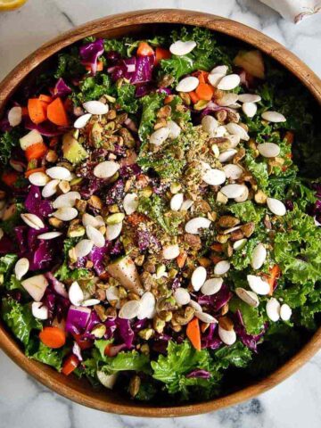 kale crunch salad with crunchy toppings in bowl.
