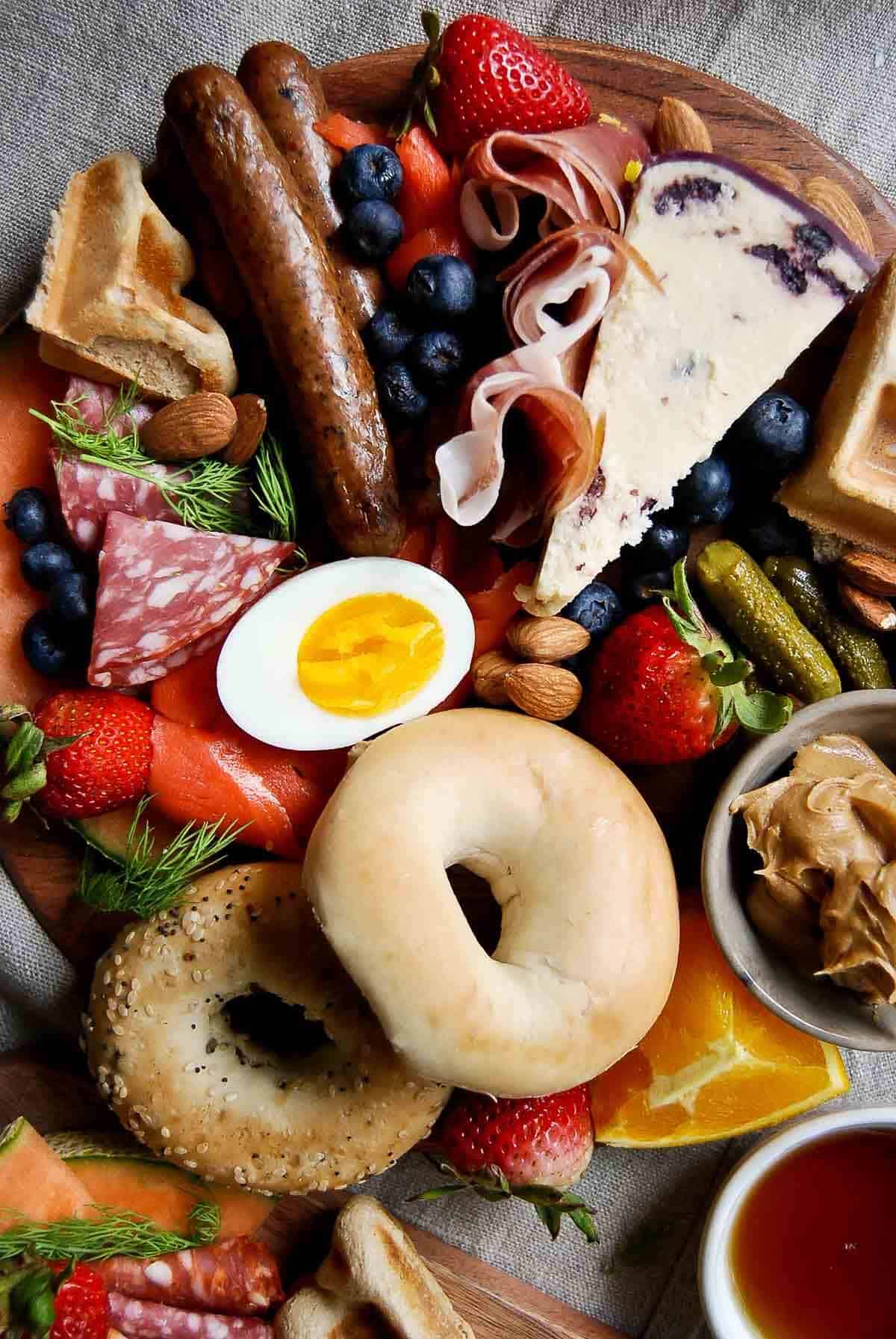 loaded breakfast charcuterie boards with meat cheese and breakfast items.