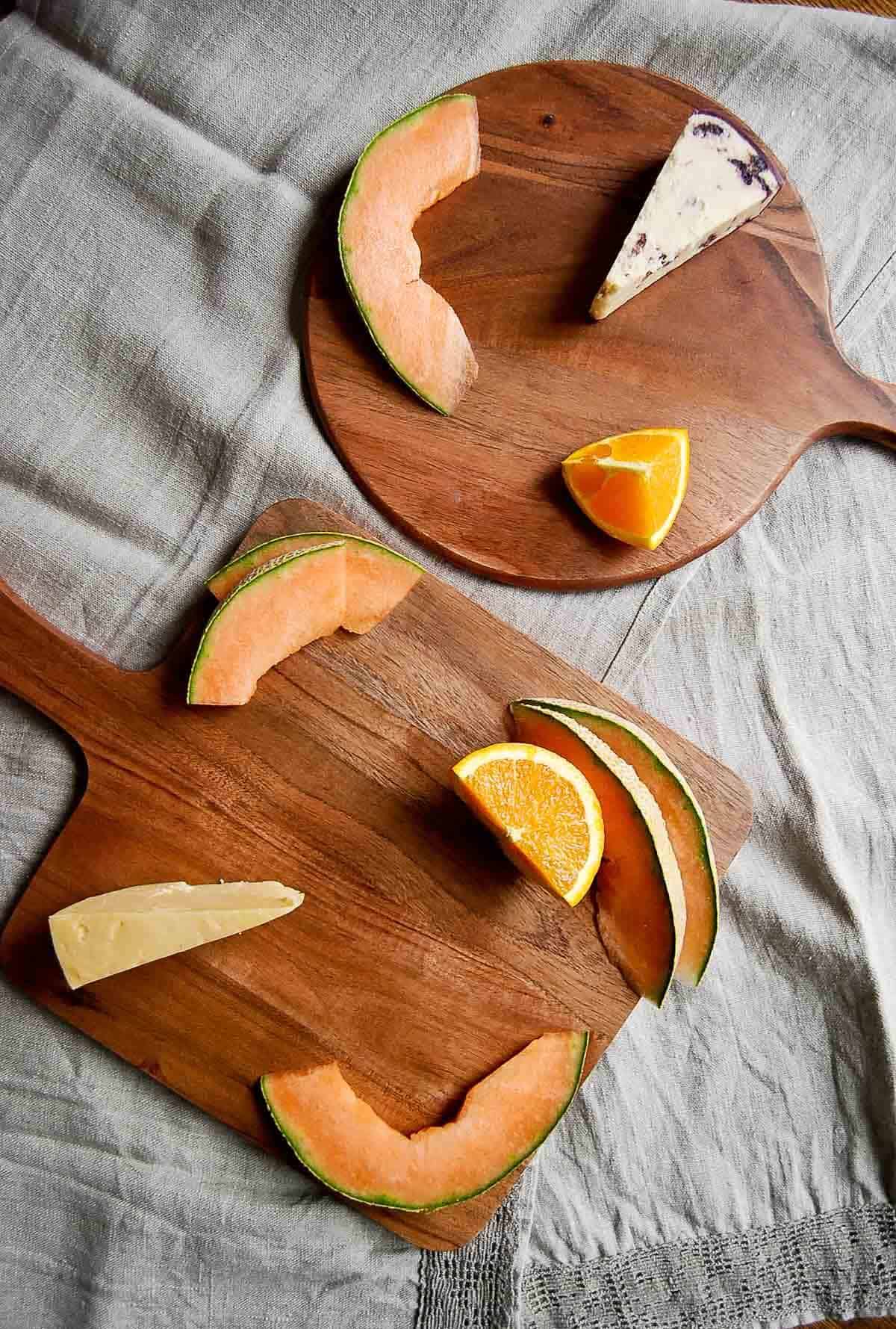 serving boards with cheese and fruit.