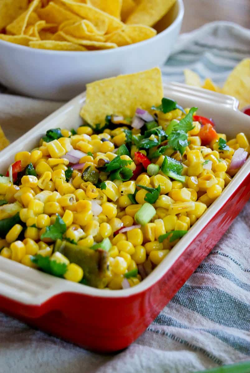 Roasted chipotle corn salsa in bowl with chips.