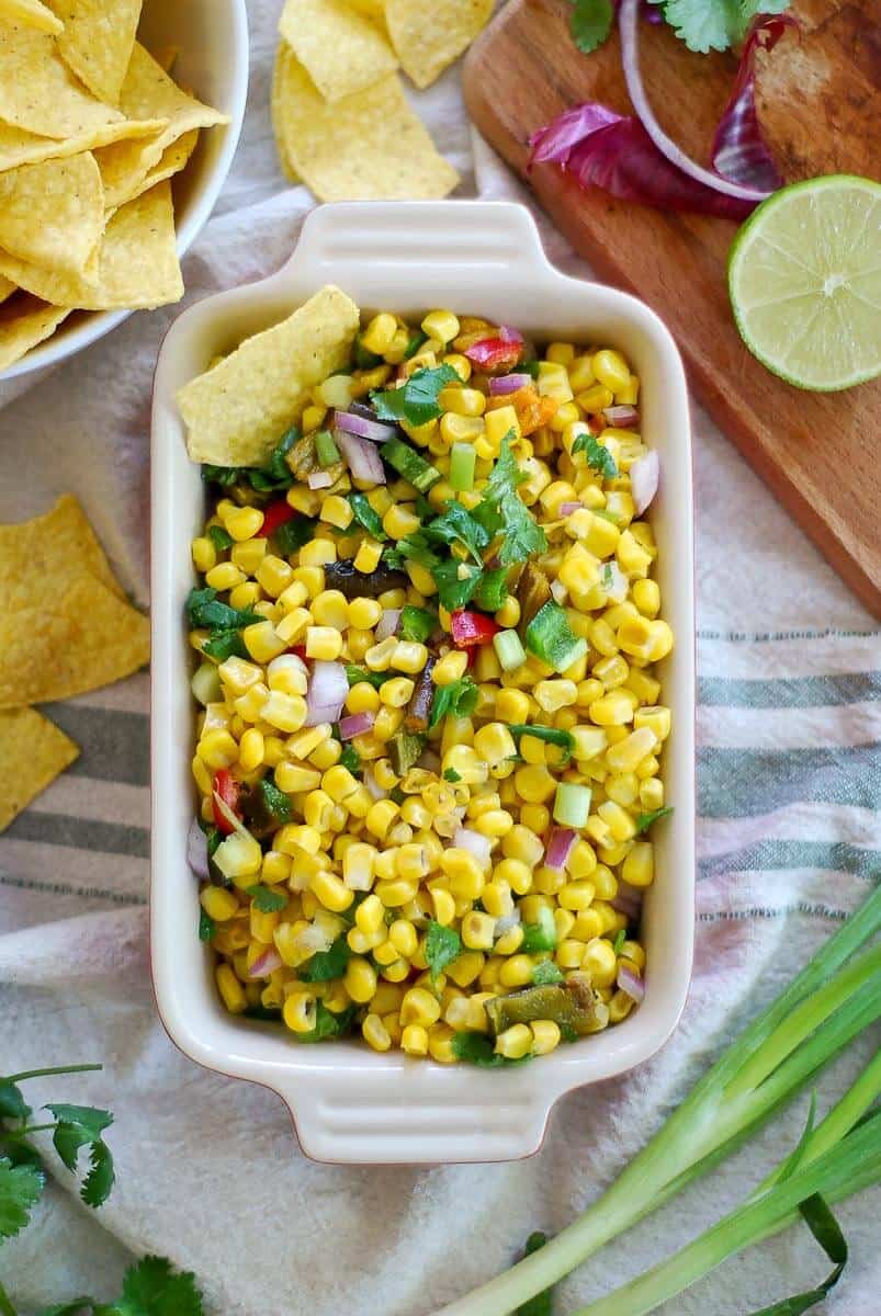 Roasted chipotle corn salsa in bowl with chips.