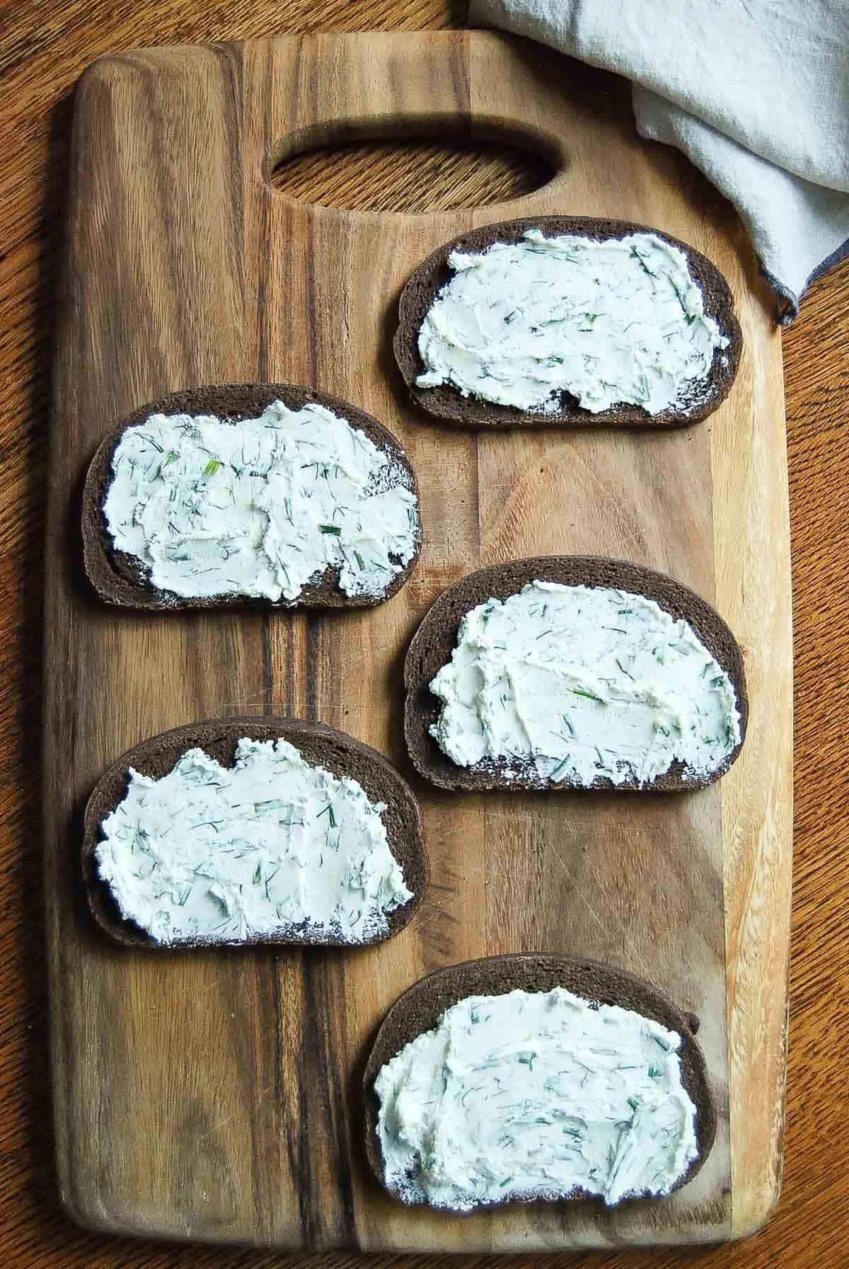 pumpernickel bread slices with herbed cream cheese.