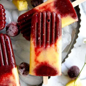 closeup of cherry pineapple popsicle.