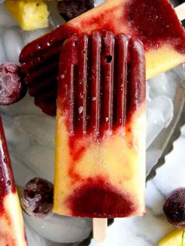 closeup of cherry pineapple popsicle.