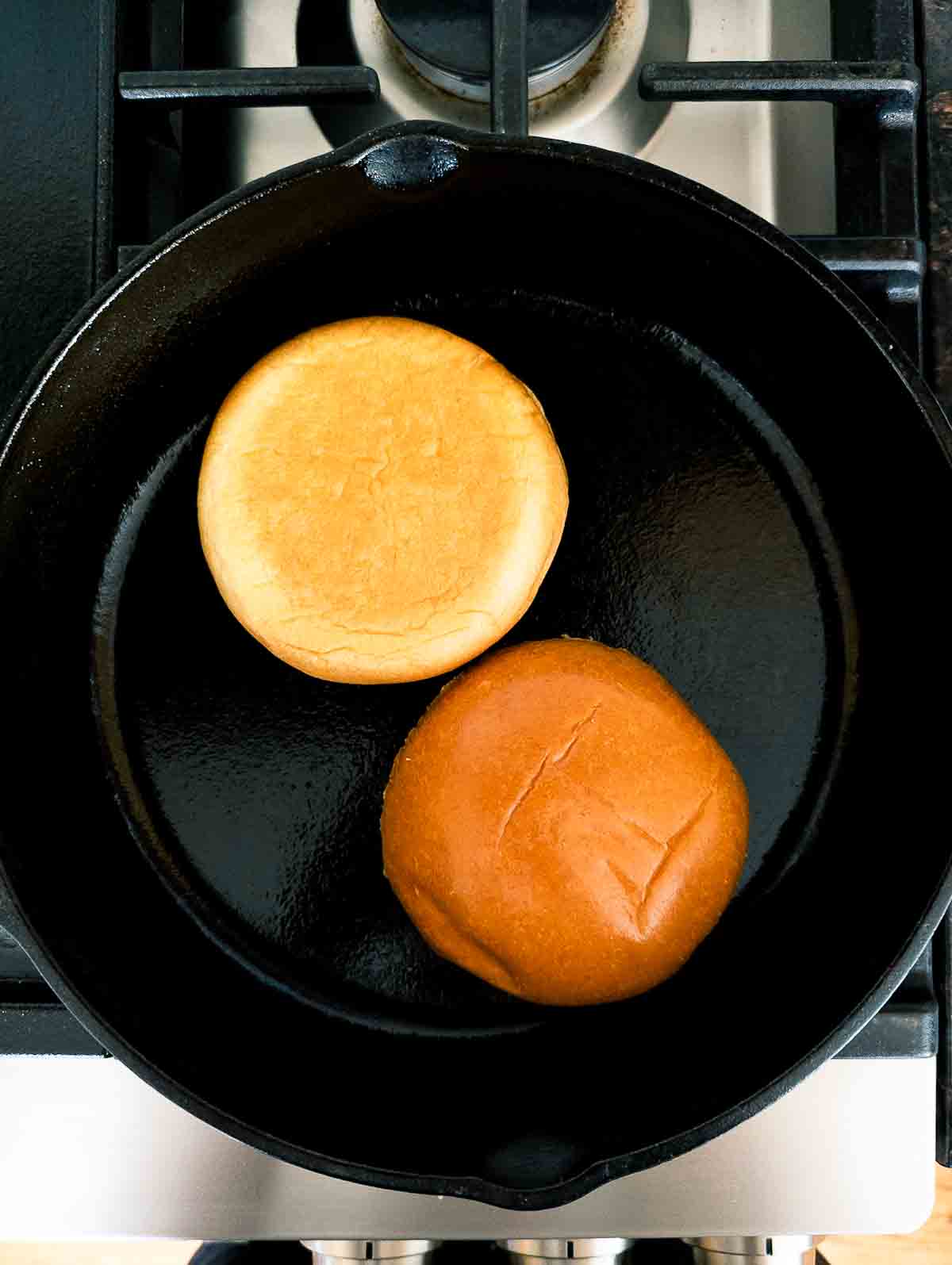 brioche bun toasting in skillet.