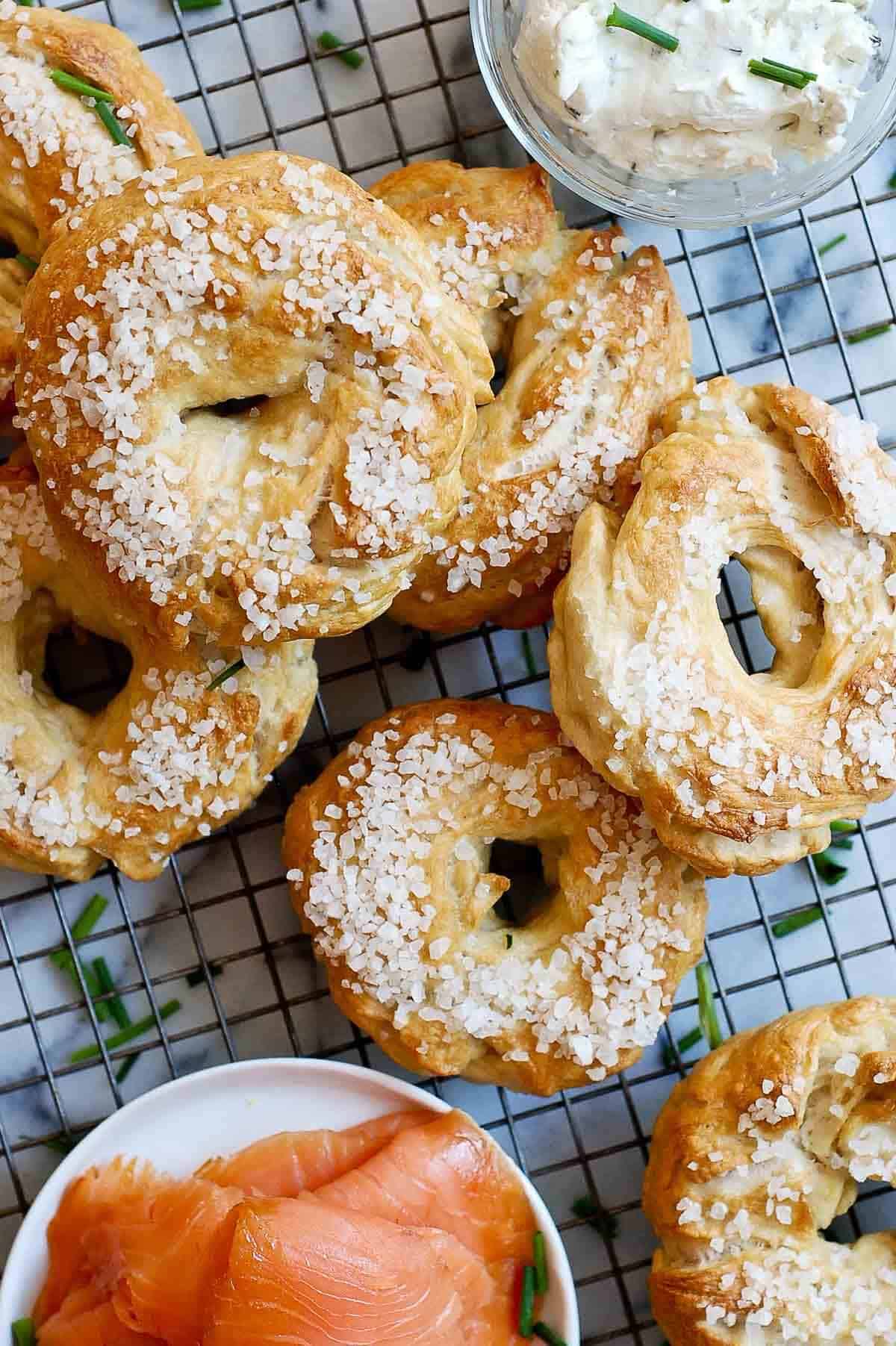 stacked homemade bagels on cooling rack.