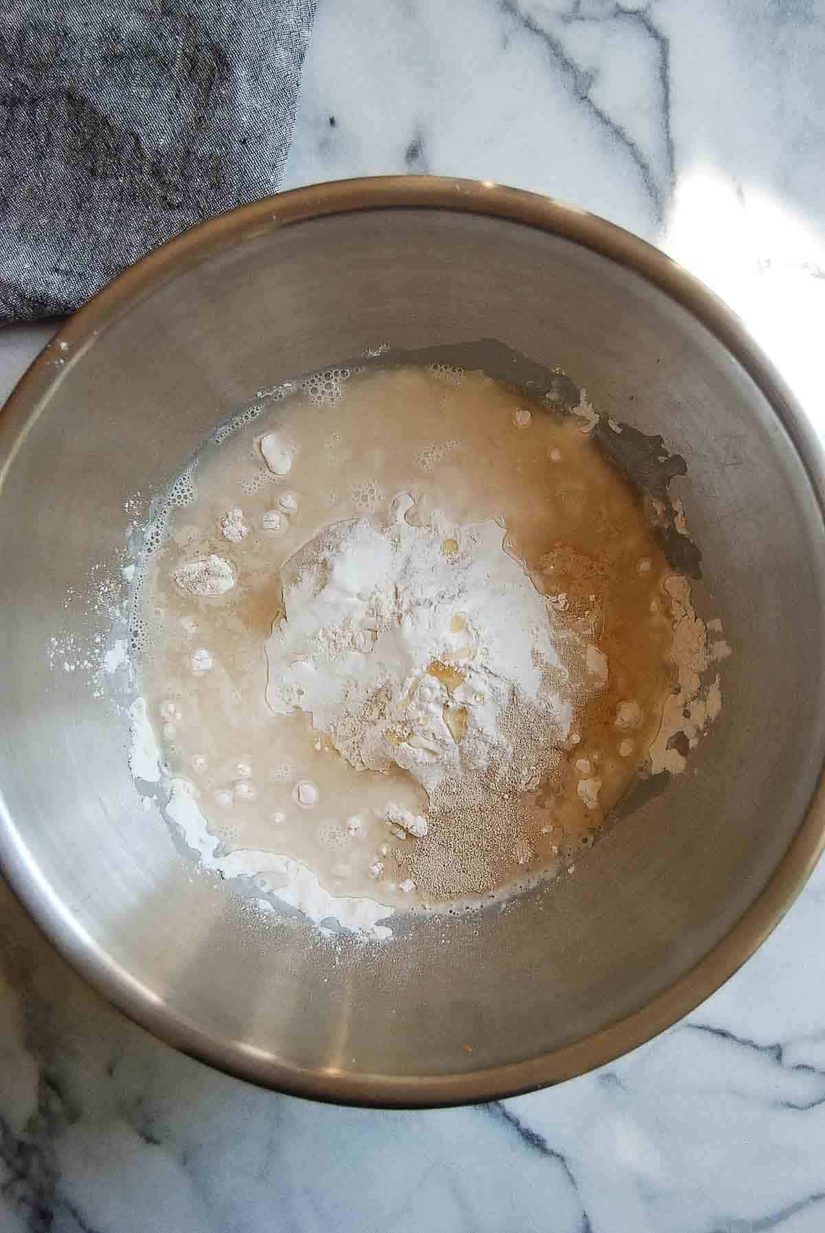 flour, salt water and yeast mixed in a bowl.
