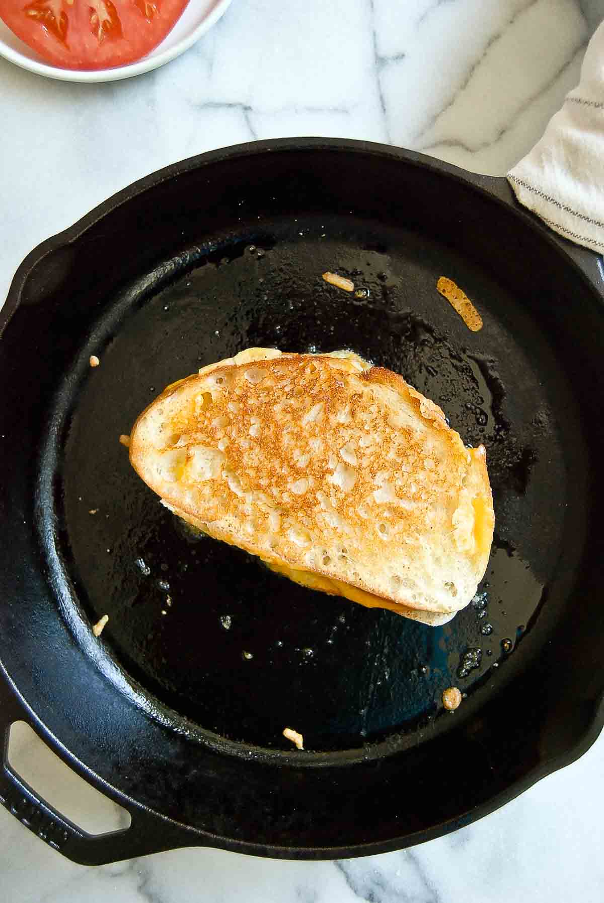 crispy sourdough grilled cheese in cast iron skillet.