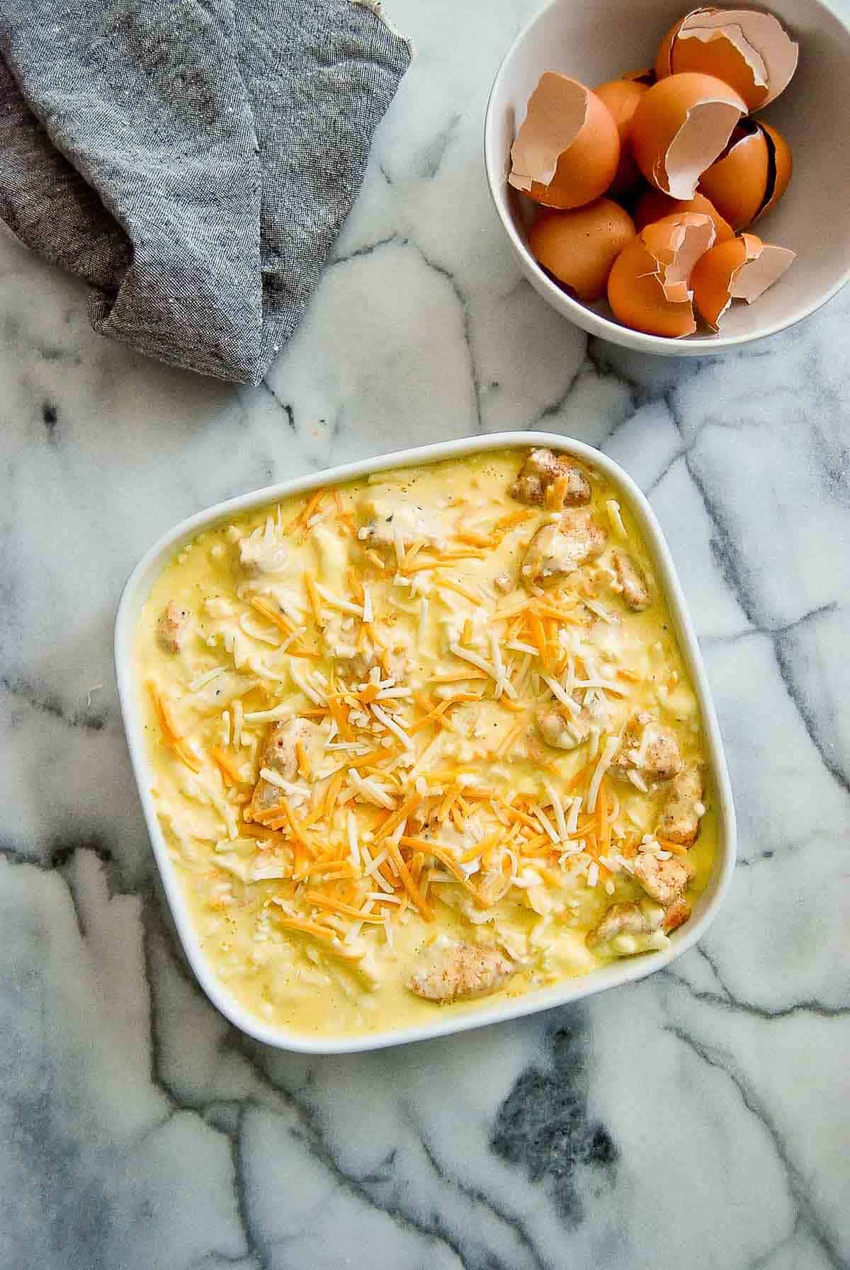 chicken, hash browns, cheese and egg mixture in casserole dish.