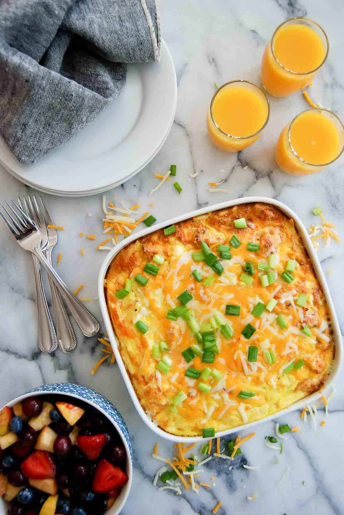 baked 5-ingredient chicken hash brown casserole with fruit and juice on the side.