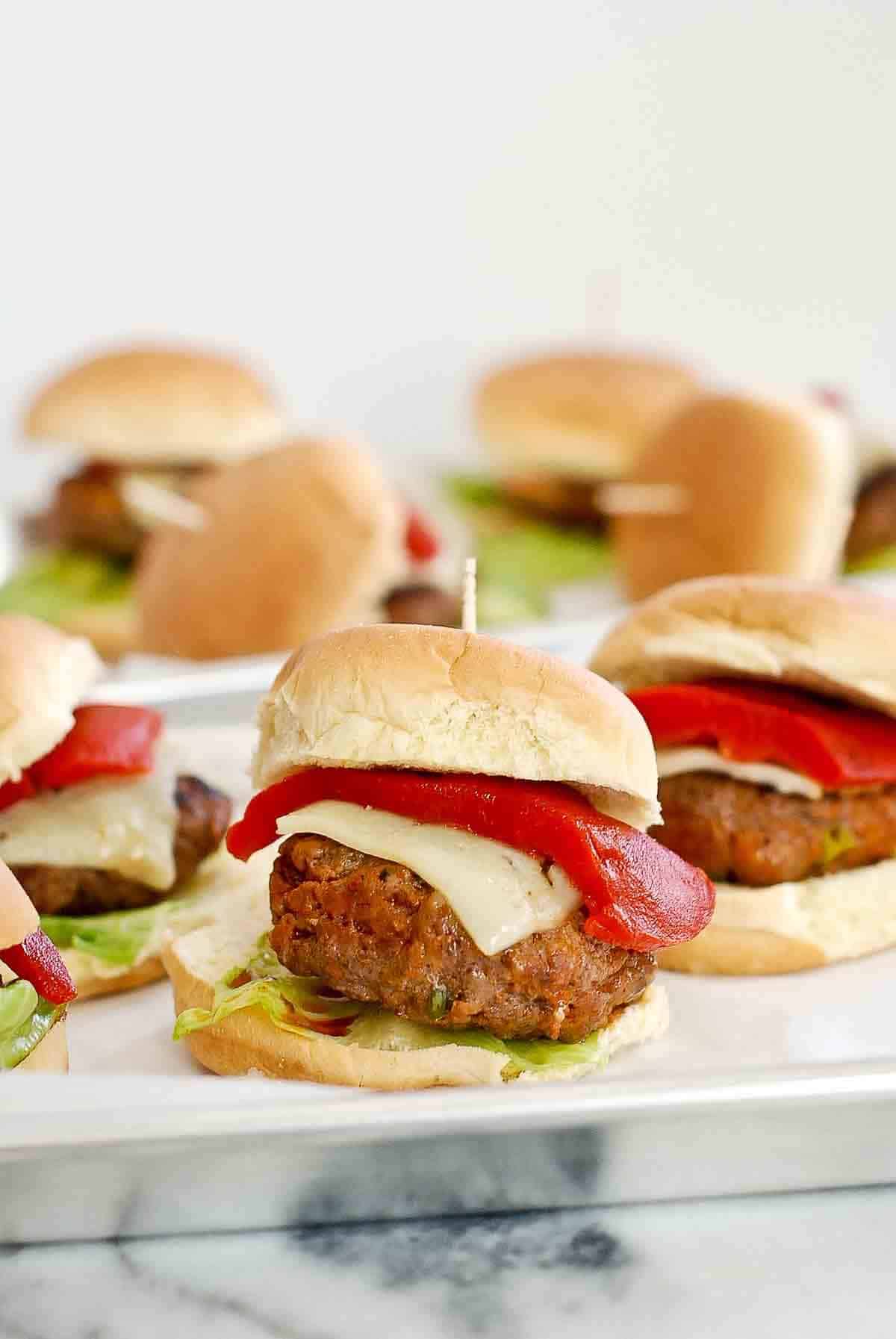 Closeup of mini spanish burgers on tray.