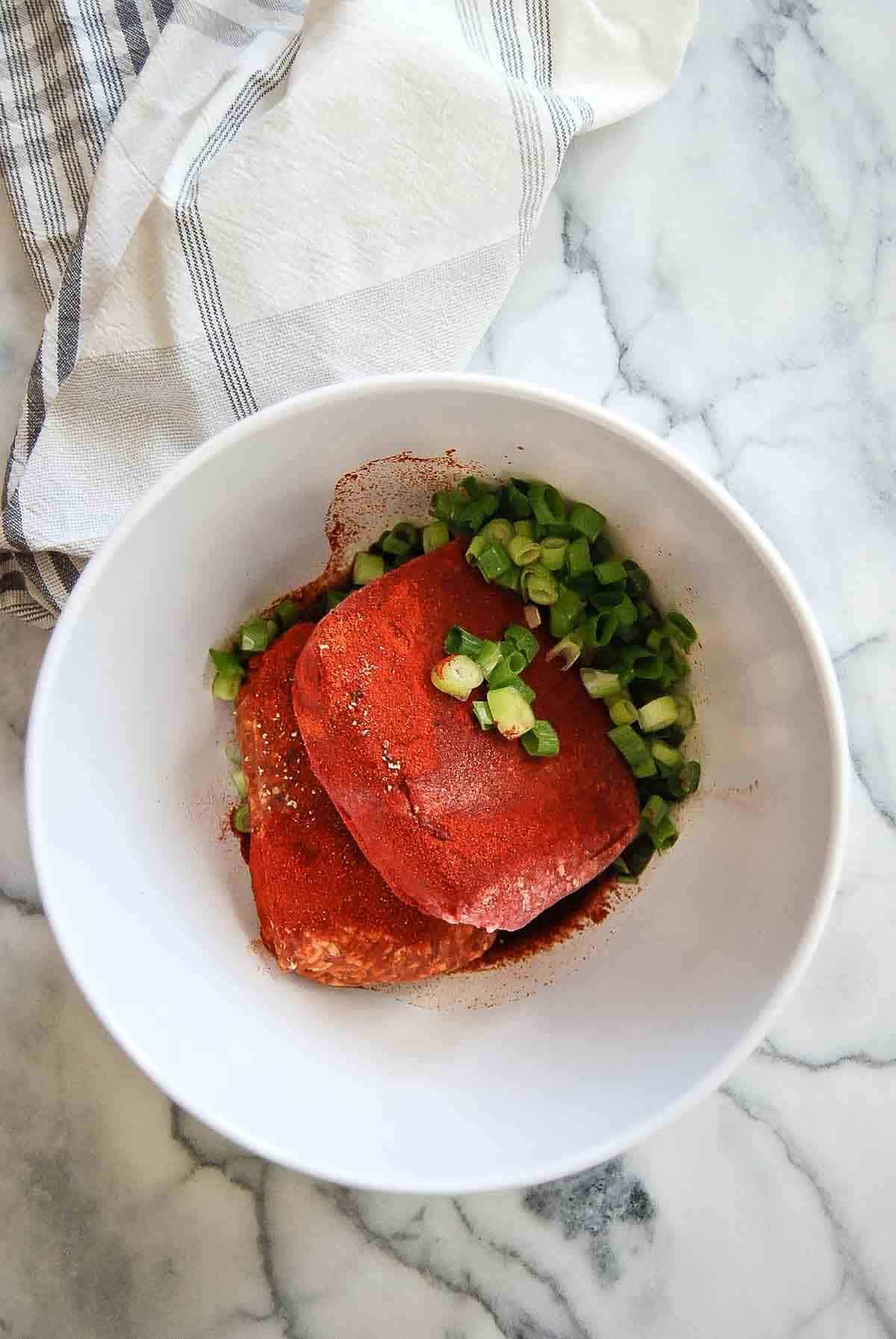 ground beef, chorizo and seasoning in bowl.