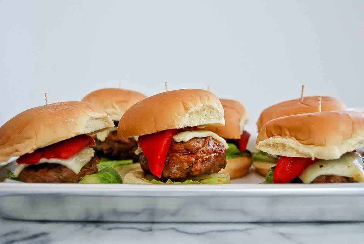 Closeup of three spanish sliders on serving tray.