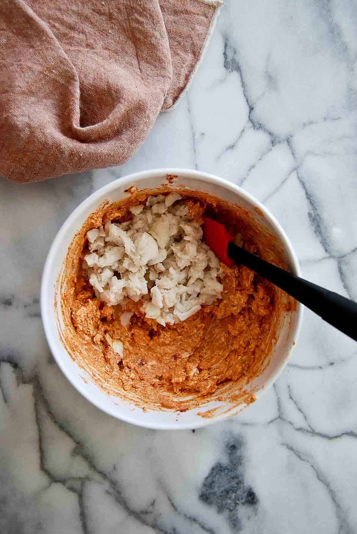 cream cheese mixture with lump cajun crab meat in bowl.