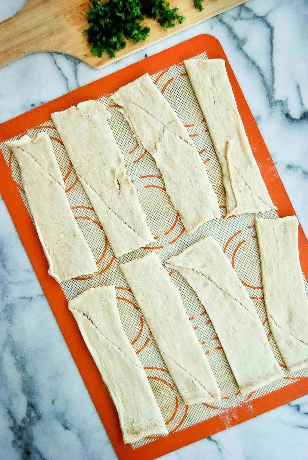 crescent roll dough cut into strips.