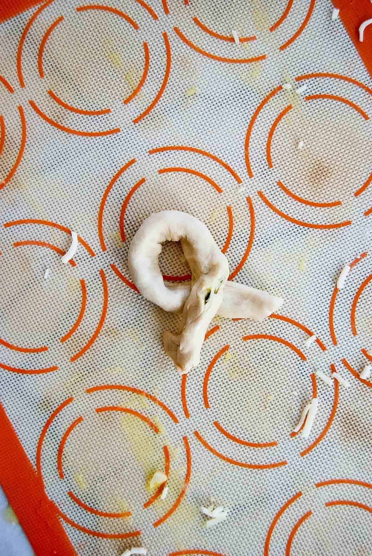 closeup of how to tie a garlic knot.