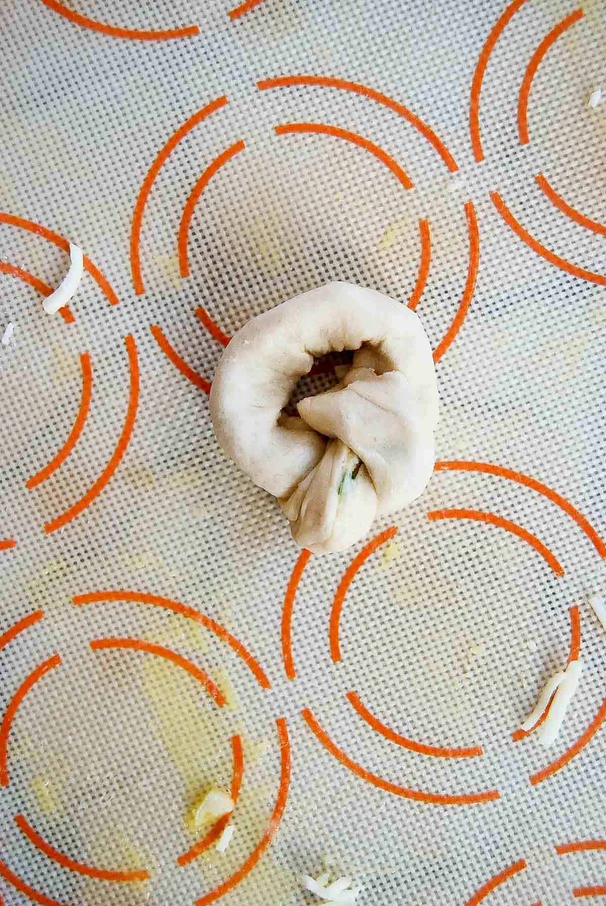 closeup of how to tie a garlic knot.