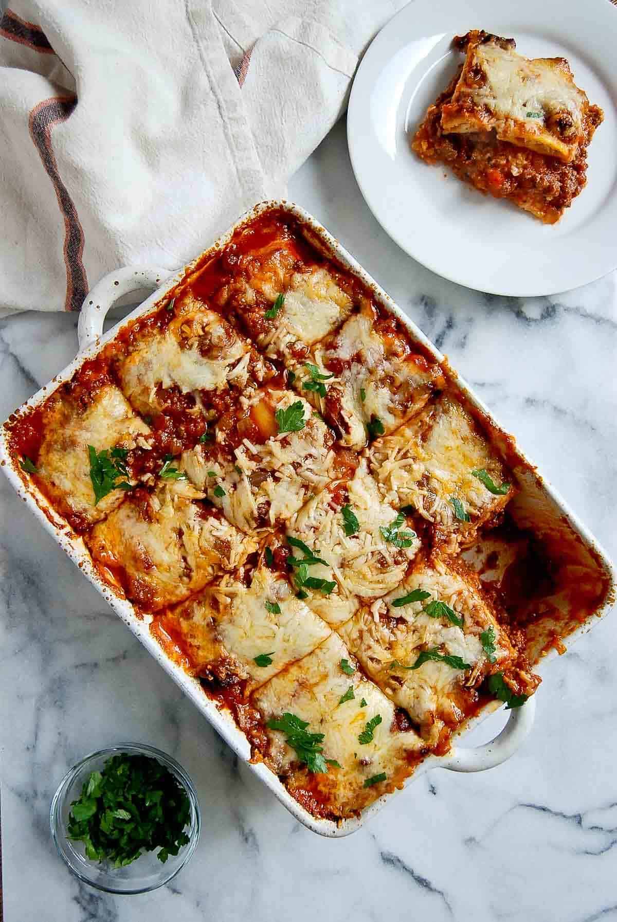 lazy lasagna in casserole dish with piece cut out.