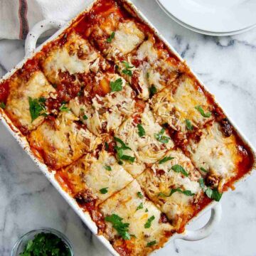 closeup of lazy lasagna with frozen cheese ravioli, pieces cut.