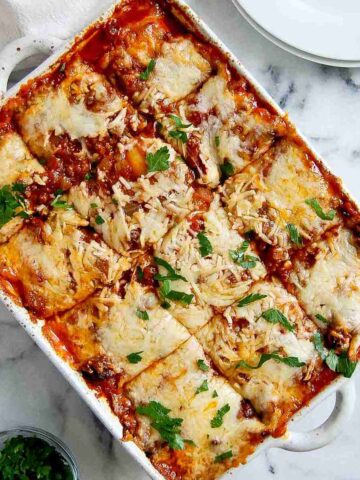 closeup of lazy lasagna with frozen cheese ravioli, pieces cut.