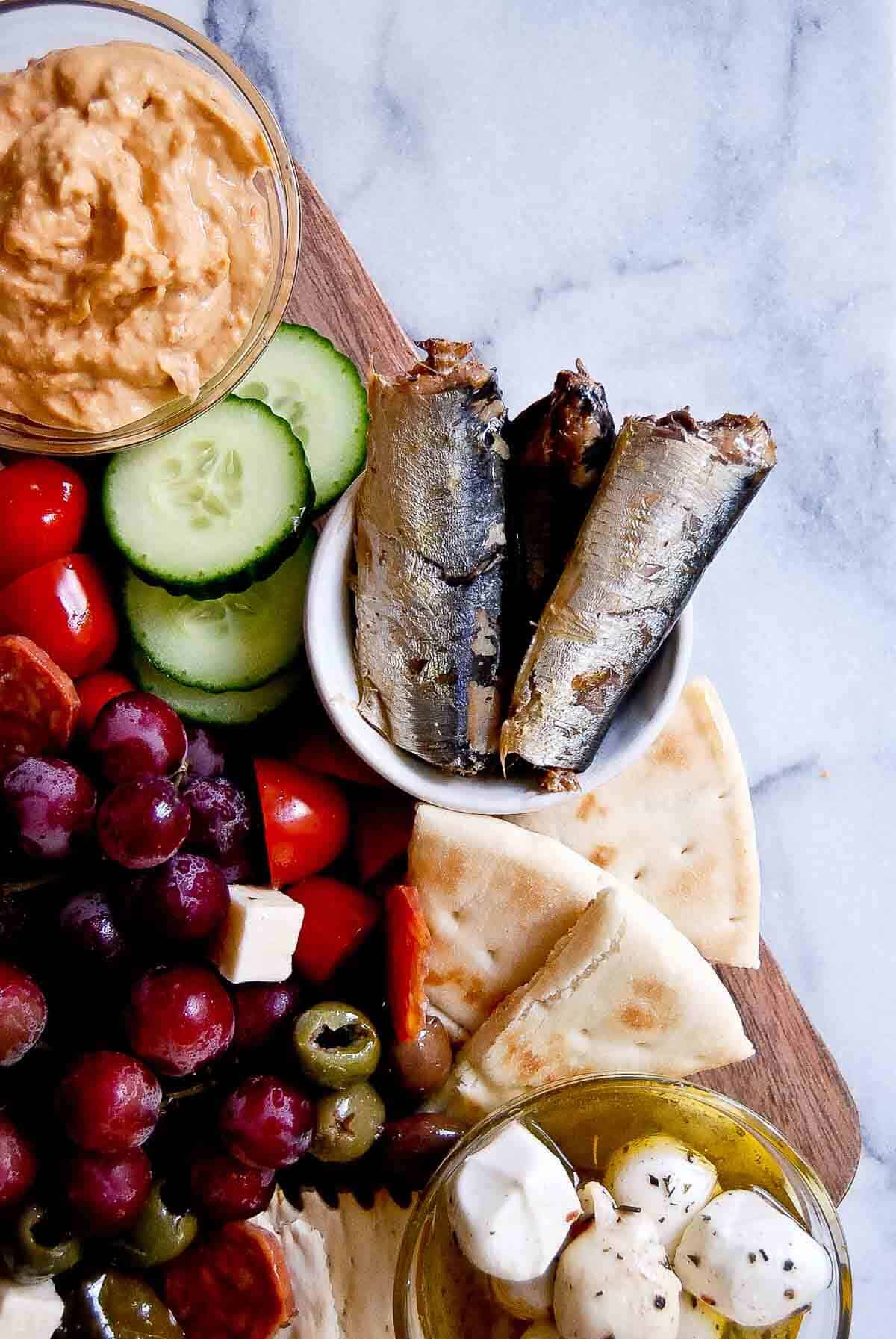 closeup of sardines and pita bread.