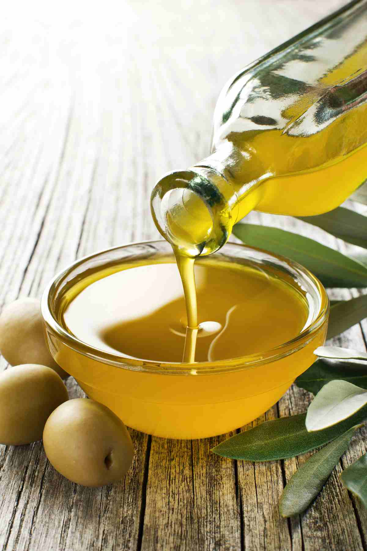 olive oil being poured into a small bowl.