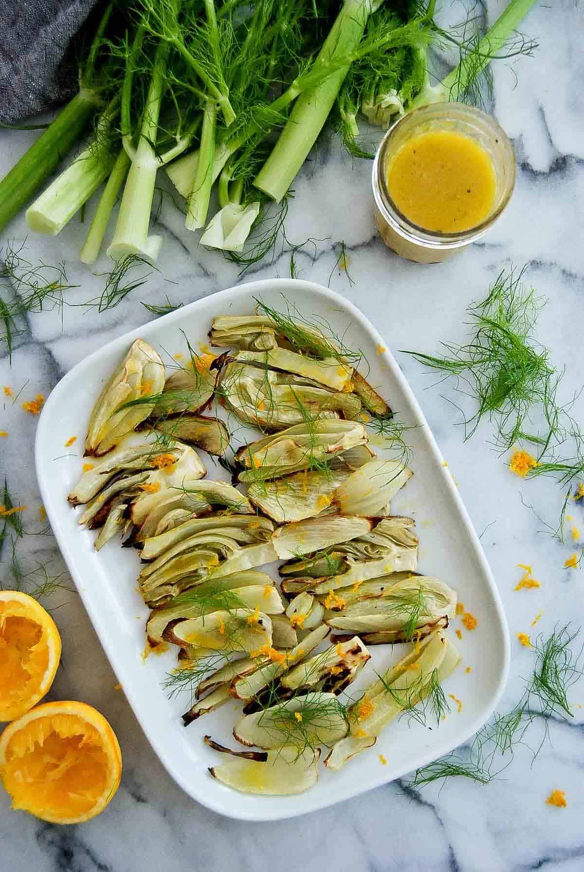 roasted fennel salad with orange honey dressing on serving plate.