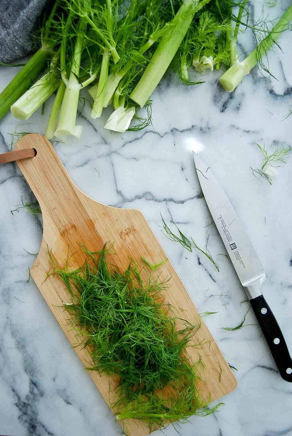 fennel fronds on cutting board.