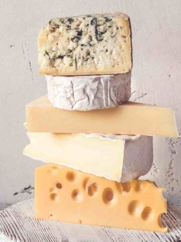 stack of cheeses on cutting board, 27 best american cheese substitutes
