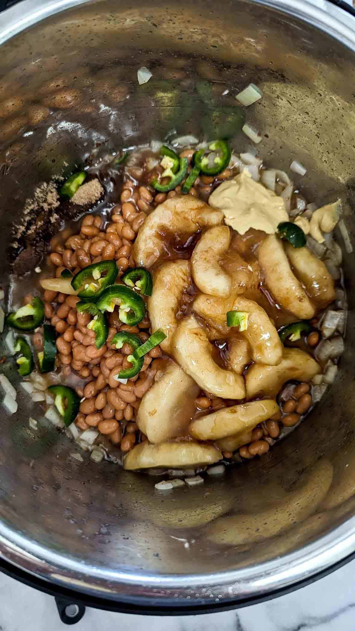 slow cooker apple pie baked bean ingredients in crock pot.