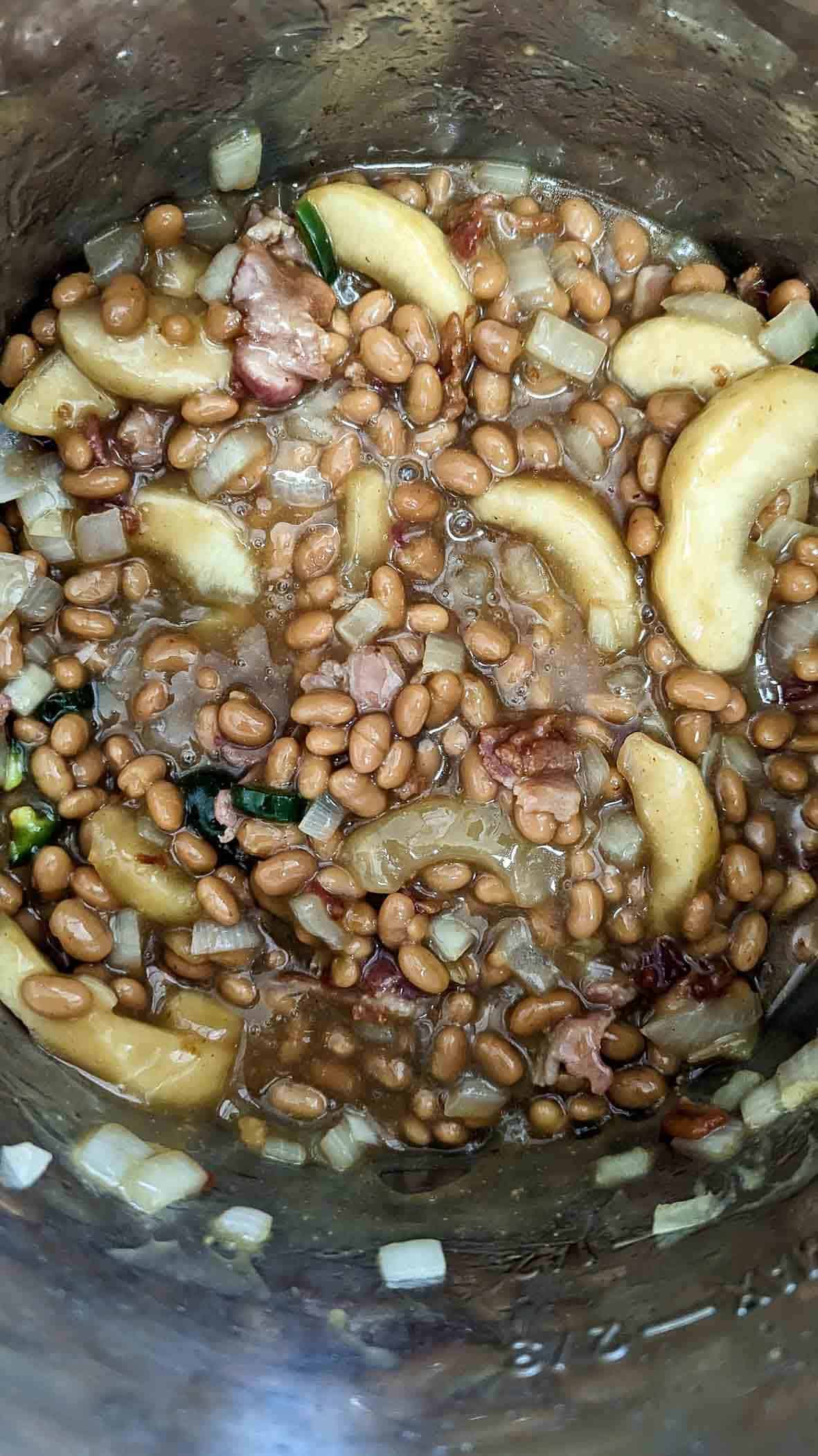 slow cooker apple pie baked bean ingredients in crock pot.