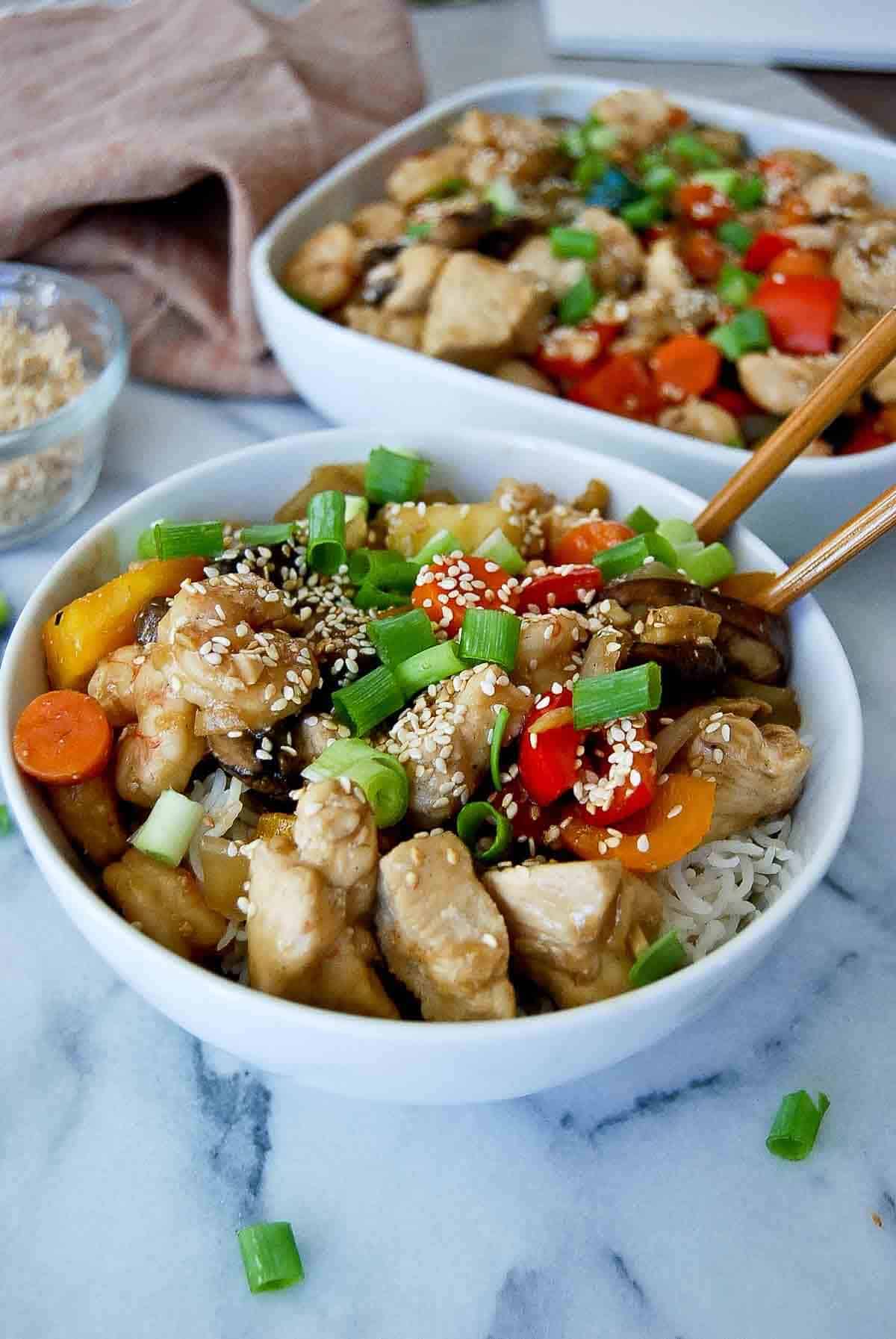 side view of chicken and shrimp stir fry with garlic ginger sauce.