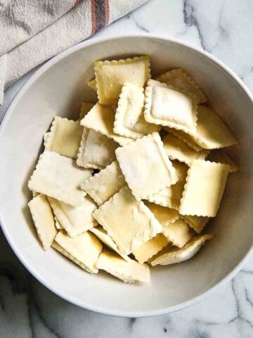 frozen ravioli in bowl on countertop.