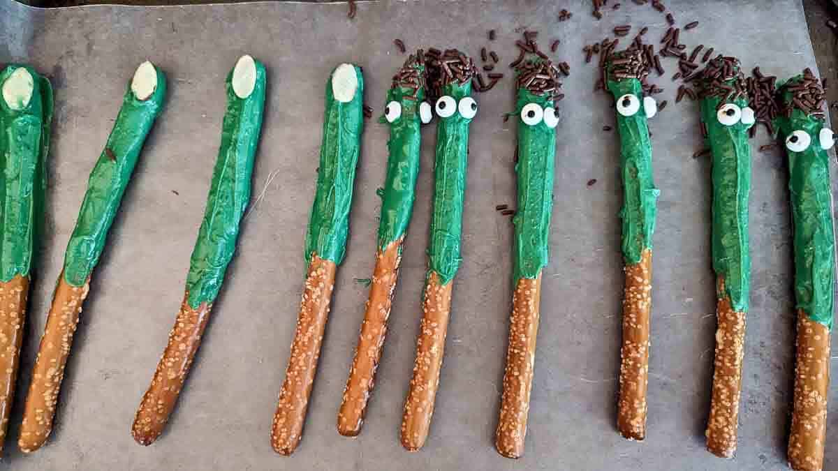 assembly of witch finger halloween pretzel rods and Frankenstein pretzel rods.