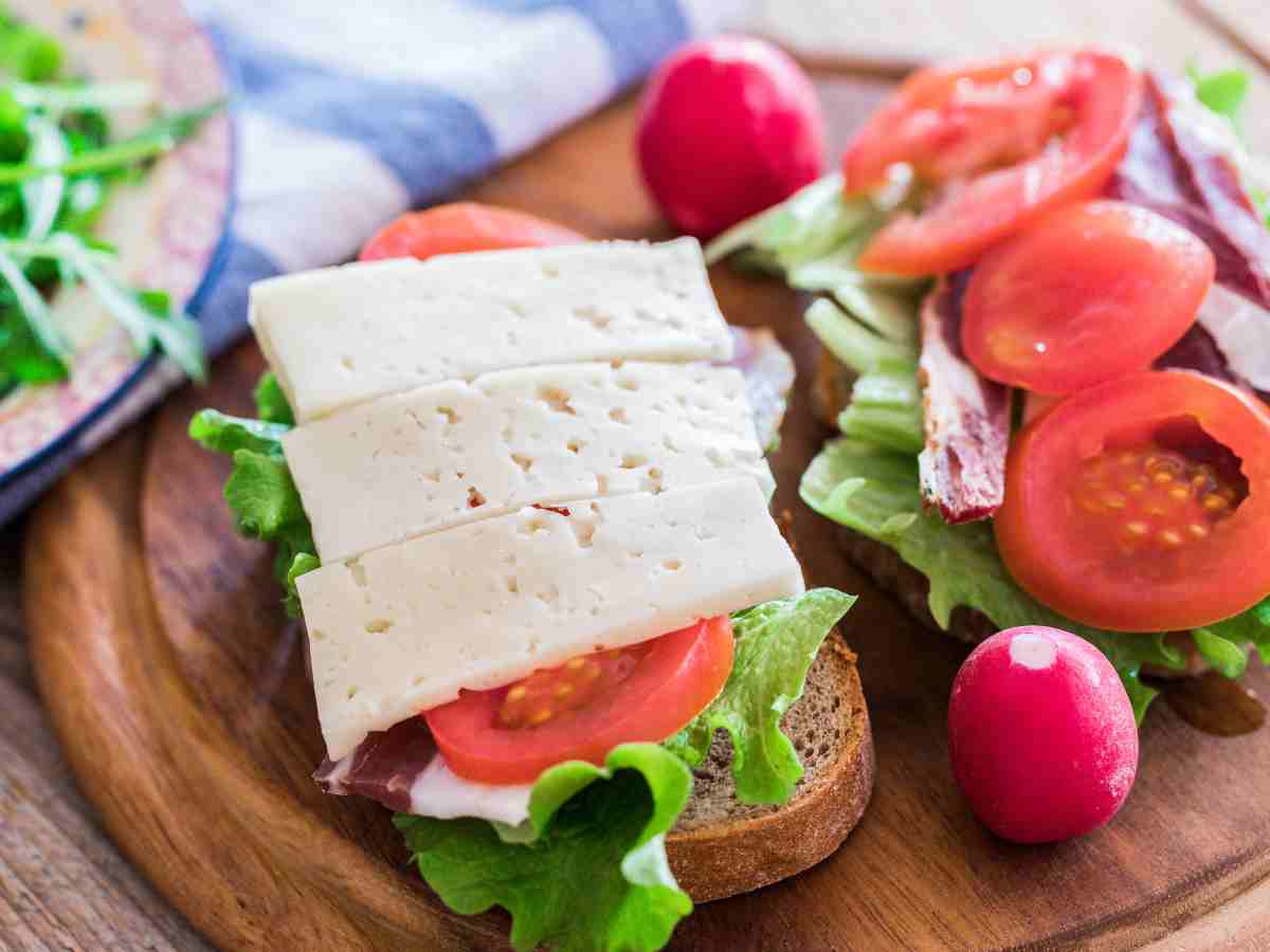 slices of havarti cheese on sandwich.