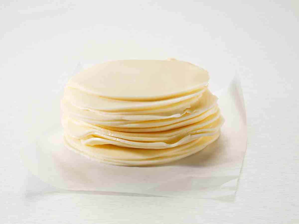 stack of provolone cheese on counter top.