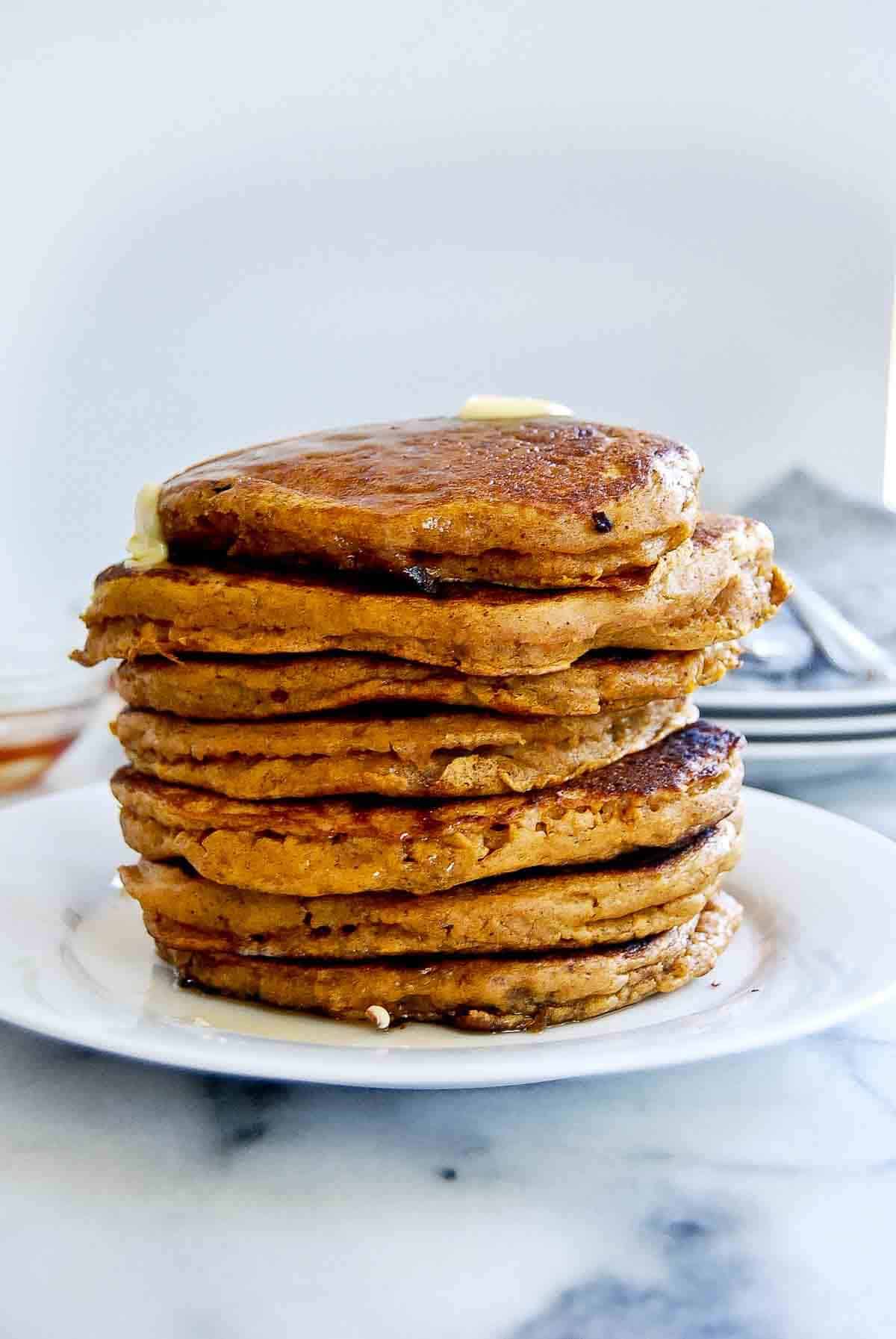 side view of pumpkin pancakes from pancake mix, stacked on plate.