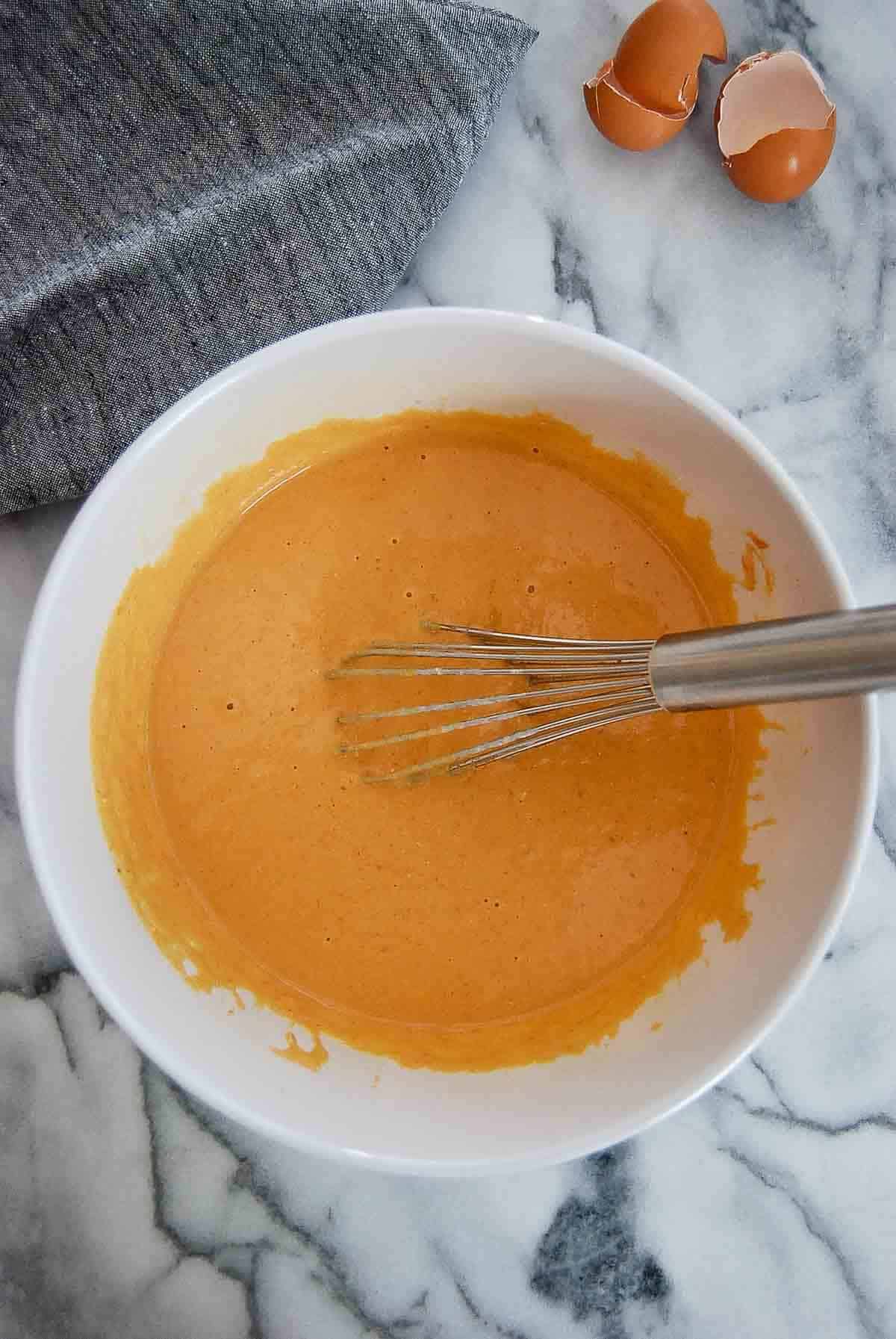 wet ingredients for pumpkin pancake mix in bowl.