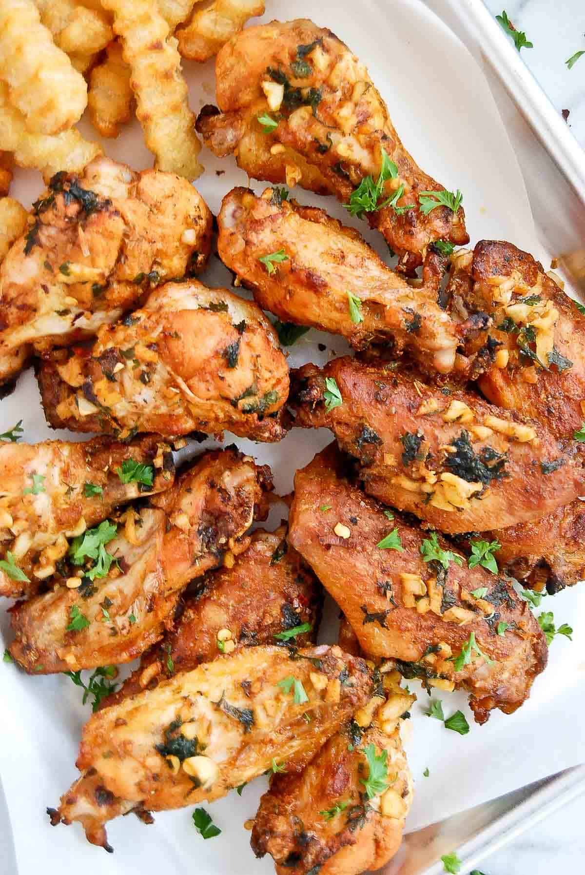 close up of baked spanish chicken wings on tray.