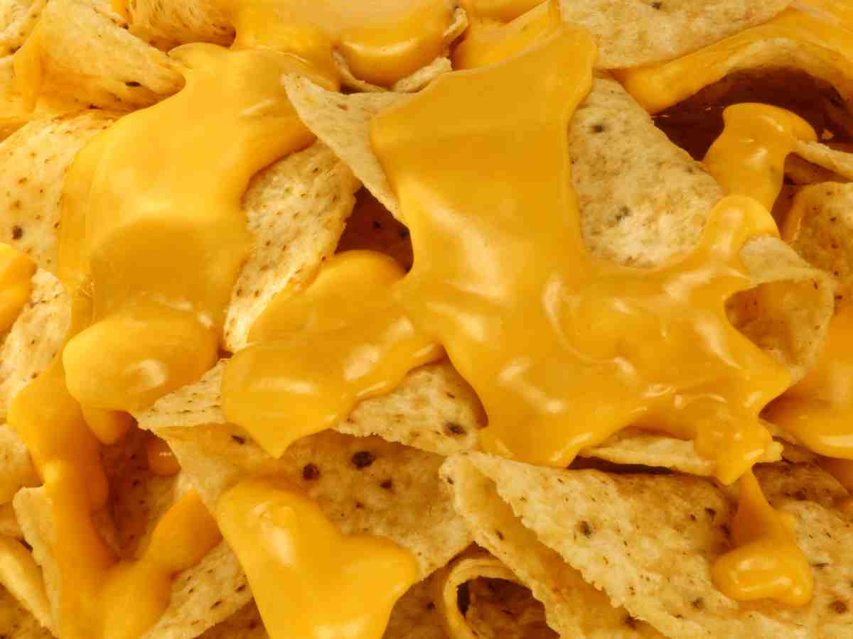 american cheese melted onto tortilla chips.