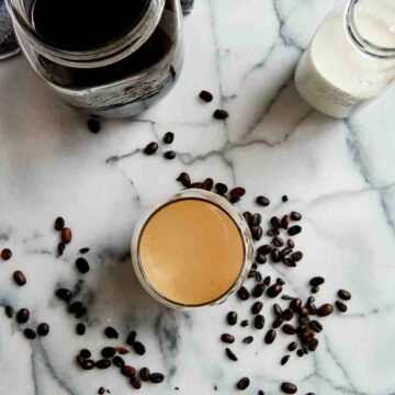 cold brew coffee in cup with half n half mixed in.