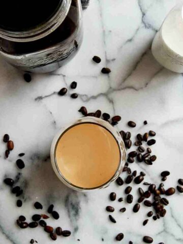 cold brew coffee in cup with half n half mixed in.